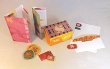 Photograph of restaurant branding by Graphic Design student including menus and business cards